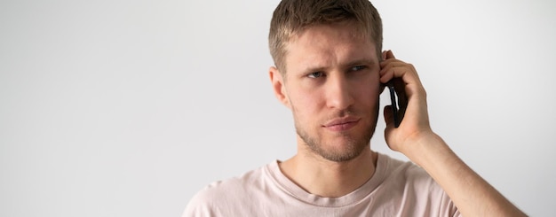 A young bearded guy making a phone call