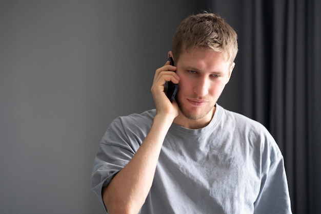 A young bearded guy making a phone call