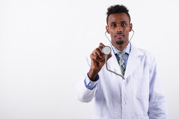 Young bearded man doctor against white