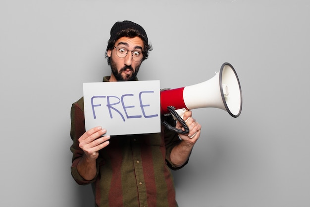 Young bearded man protesting with a megaphone