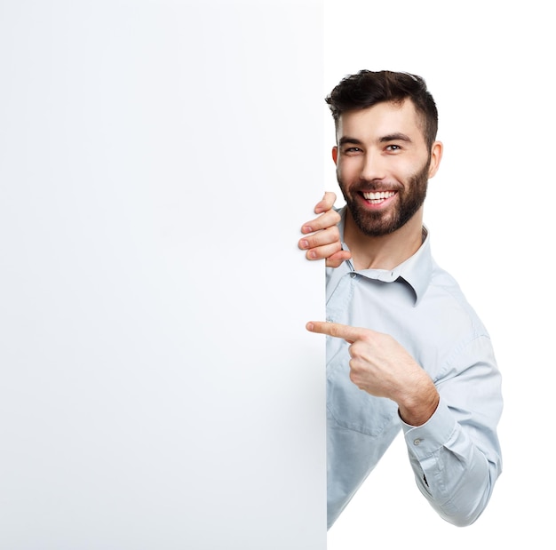 A young bearded man showing blank signboard isolated over white background