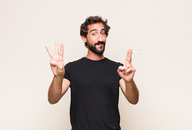 Young bearded man smoking a cigarette