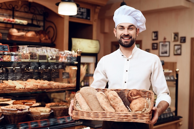 Young Bearded Man in White Cap Standing in Bakery.