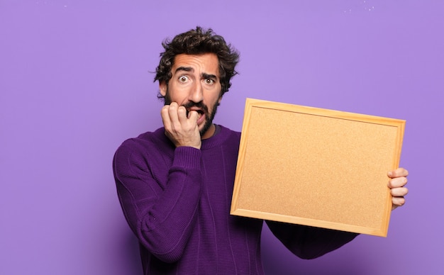 Young bearded man with a blank banner