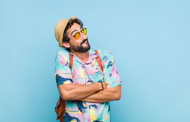 Young bearded tourist man shrugging