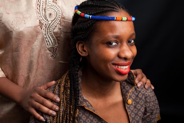 Young beautiful African fashion model couple in love in traditional dress with a bowl