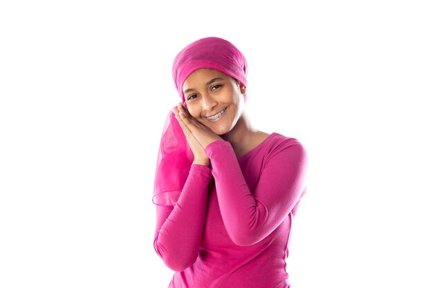 Young beautiful African woman wearing pink headscarf isolated on a white background