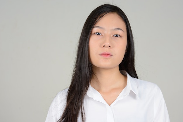 young beautiful Asian businesswoman on white