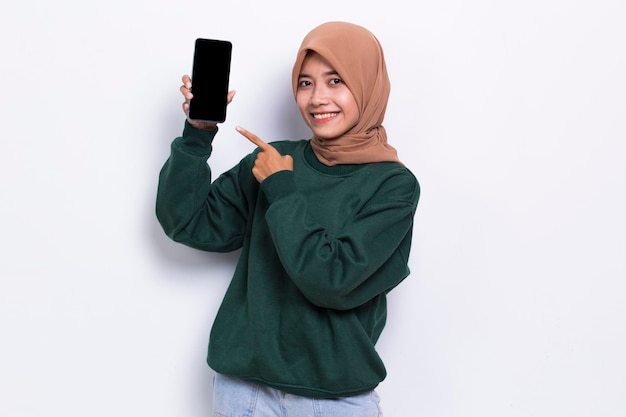 young beautiful asian muslim woman demonstrating mobile cell phone isolated on white background