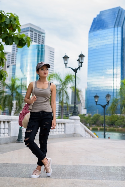 Young beautiful Asian woman relaxing at the park