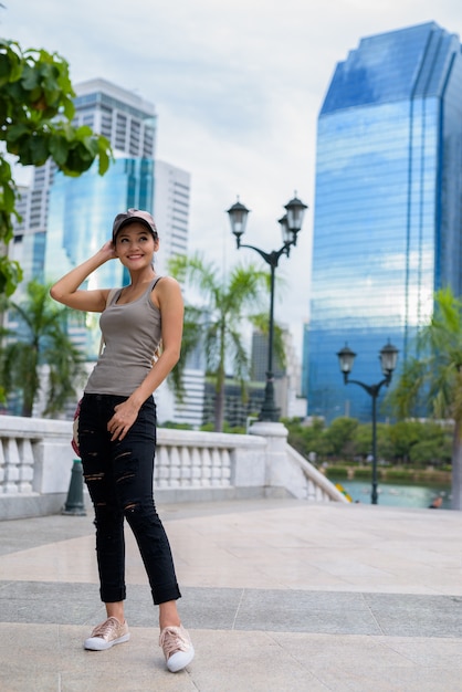 Young beautiful Asian woman relaxing at the park