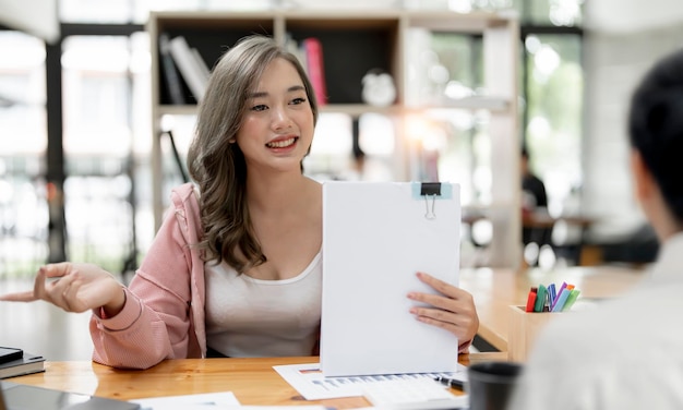 Young beautiful asian woman smiling during the job interview