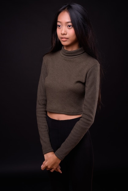 young beautiful Asian woman wearing turtleneck sweater