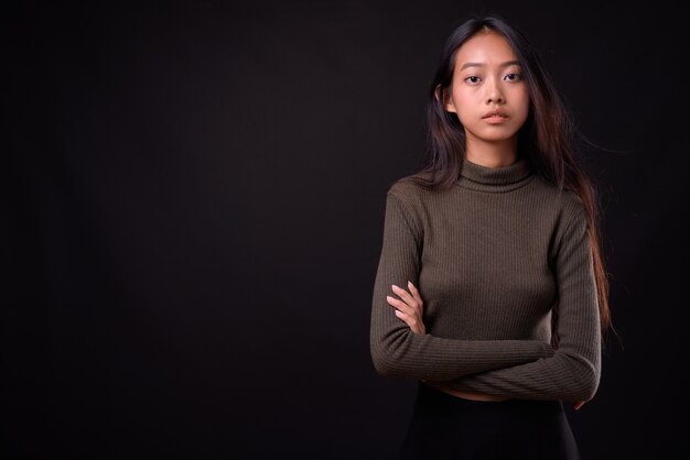 young beautiful Asian woman wearing turtleneck sweater