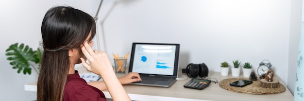 Young beautiful asian woman working at home