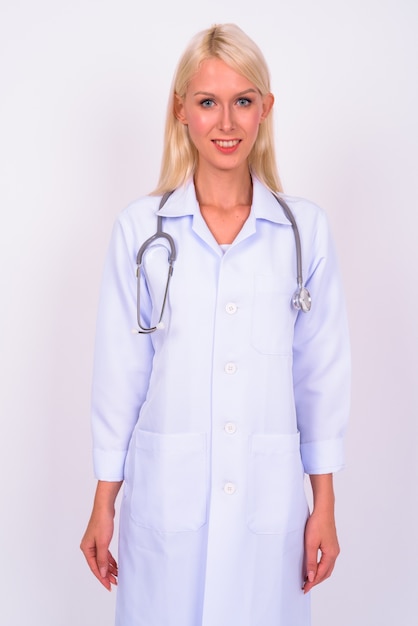 young beautiful blonde woman doctor against white space