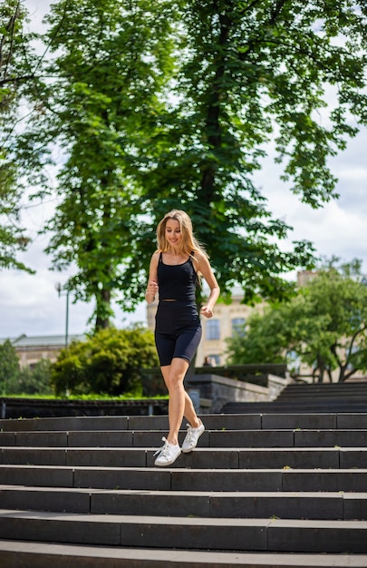 a young beautiful blonde woman runs up the stairs