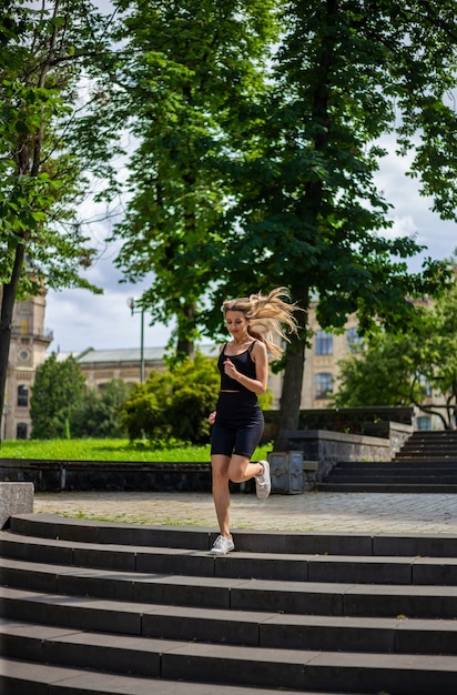 a young beautiful blonde woman runs up the stairs