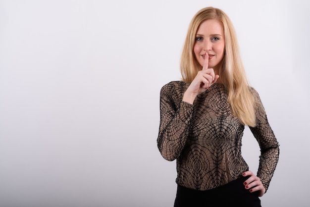 Young beautiful British woman with blond hair against white background