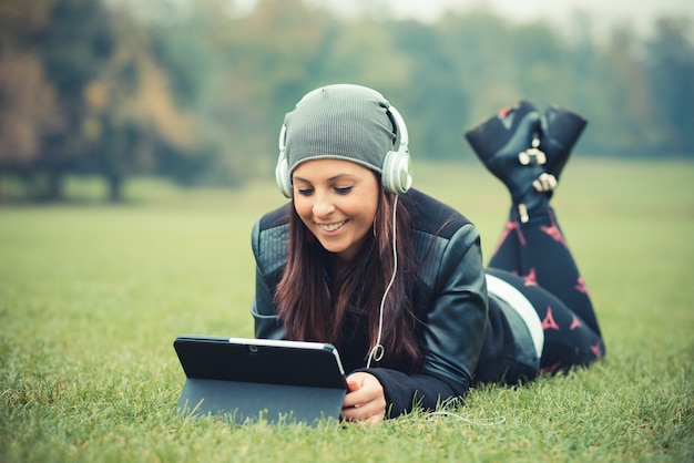 young beautiful brunette straight hair woman in the park 