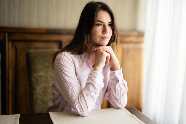 Young beautiful brunette woman sit in coffee shop cafe restaurant indoors