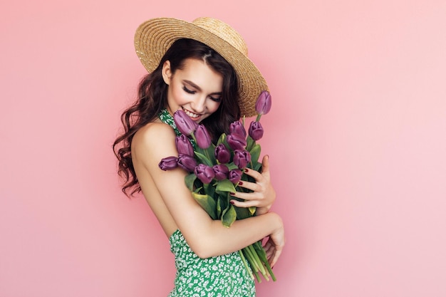 Young beautiful brunette woman on vacation wearing swimsuit and Hawaiian flowers lei smiling with hands on chest with closed eyes and grateful gesture on face Health concept