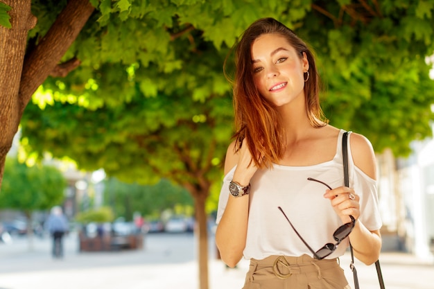 Young beautiful caucasian woman posing outdoor in the city