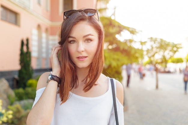 Young beautiful caucasian woman posing outdoor in the city