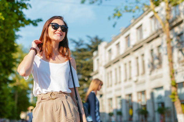 Young beautiful caucasian woman posing outdoor in the city