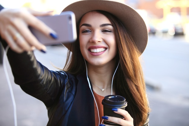 Young beautiful caucasian woman taking selfie outdoor