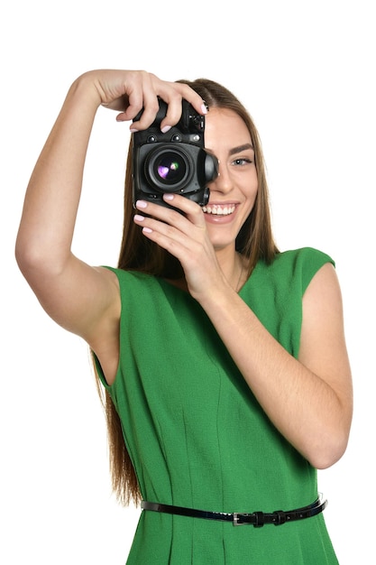 Young beautiful caucasian woman with camera over white background