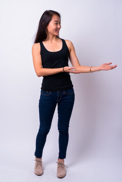  young beautiful Chinese woman against white wall