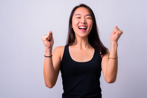  young beautiful Chinese woman against white wall