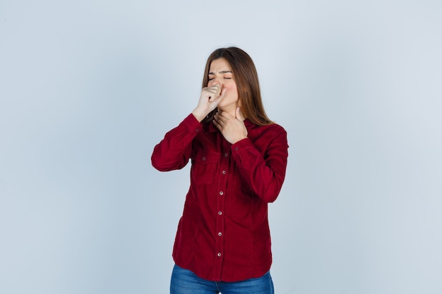 Young beautiful female suffering from cough in shirt and looking painful.