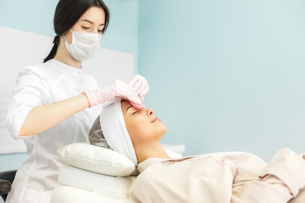 Young and beautiful girl in the clinic of natural beauty