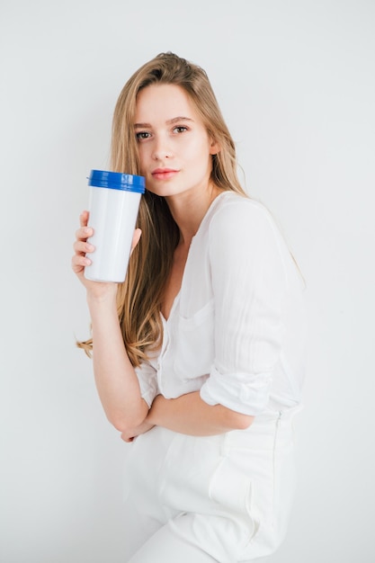 Young beautiful girl holding a useful reusable glass for comparison. The concept of sustainability and zero waste. Toning.