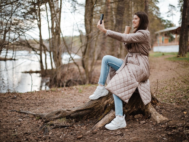 Young beautiful girl making selfie on a phone