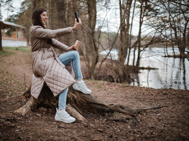 Young beautiful girl making selfie on a phone