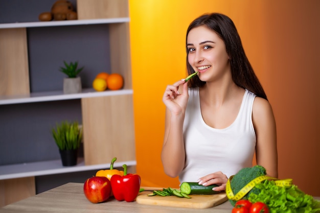 Young beautiful girl prepares a useful diet salad