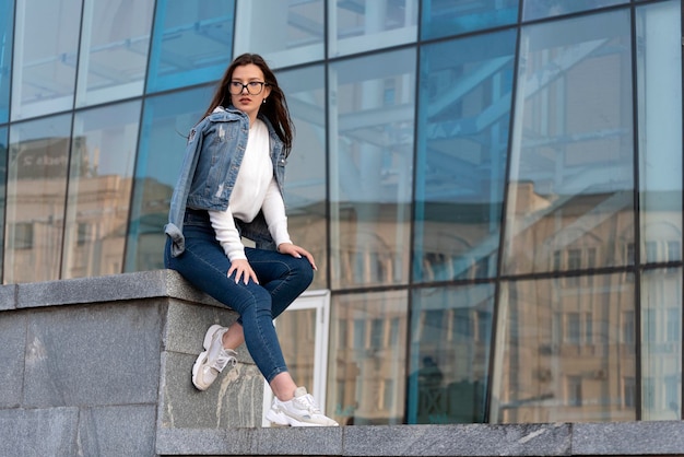 Young beautiful girl wears casual clothes and poses for photo