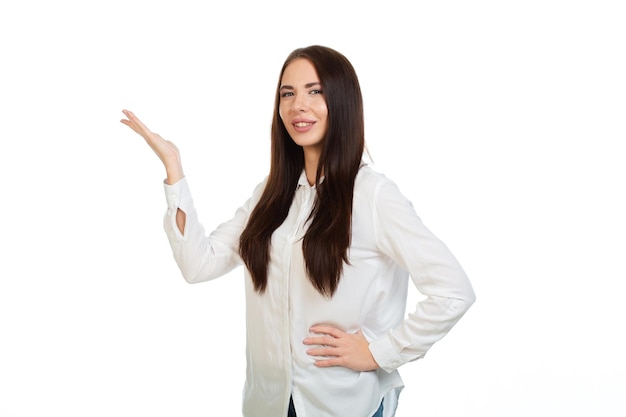 Young beautiful girl on a white background points his hands at the place for promo offers or advertising