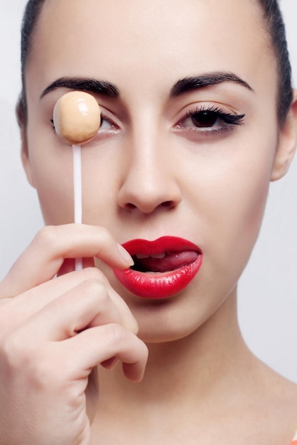 Young beautiful girl with lollipop in her mouth