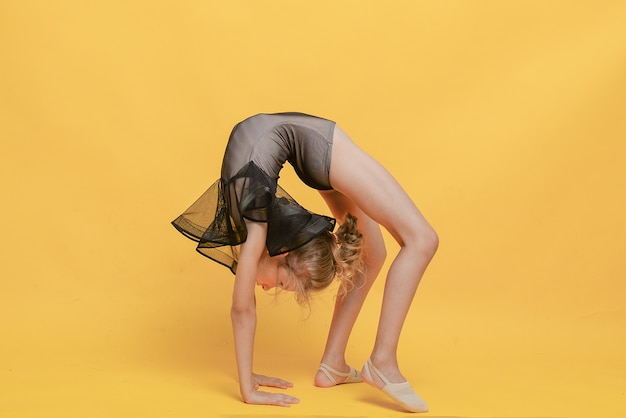 Young beautiful gymnast in sportswear performs a handstand Workout gymnastics element