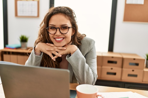 Young beautiful hispanic woman business worker using laptop working at office