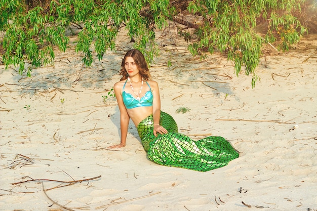 Young beautiful mermaid woman close up standing on the sea cost. Cosplay mermaid.