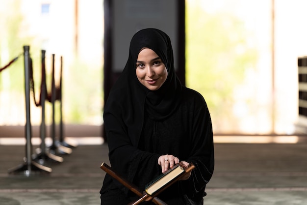 Young Beautiful Muslim Woman Praying With Quran