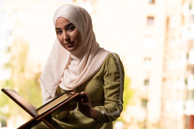 Young Beautiful Muslim Woman Praying With Quran