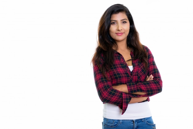 young beautiful Persian woman with arms crossed on white wall