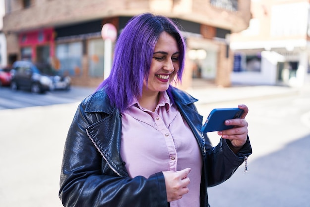 Young beautiful plus size woman smiling confident watching video on smartphone at street