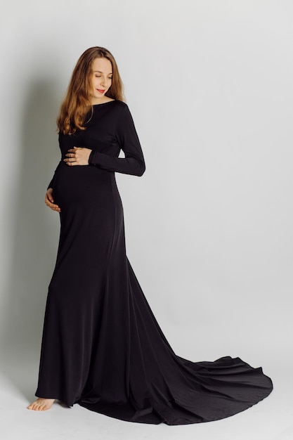 Young beautiful pregnant woman in black dress Pregnancy fashion look concept